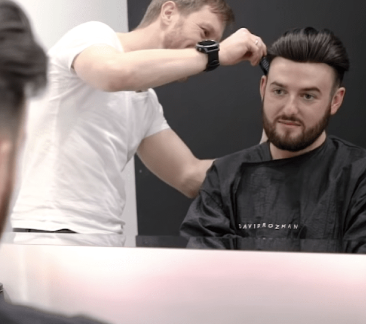 David Rozman cutting a mans hair in luxury manchester hair salon