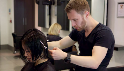 hair stylist cutting a ladies hair to look thicker