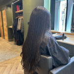 Smooth glossy straightened hair after a salon smoothing treatment shown from behind