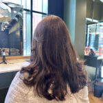 Long brown hair coloured and blown out in manchester hair salon