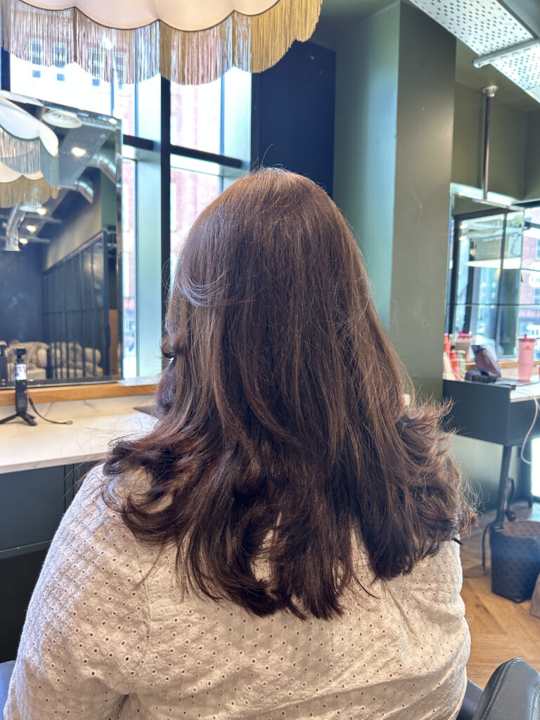 Long brown hair coloured and blown out in manchester hair salon
