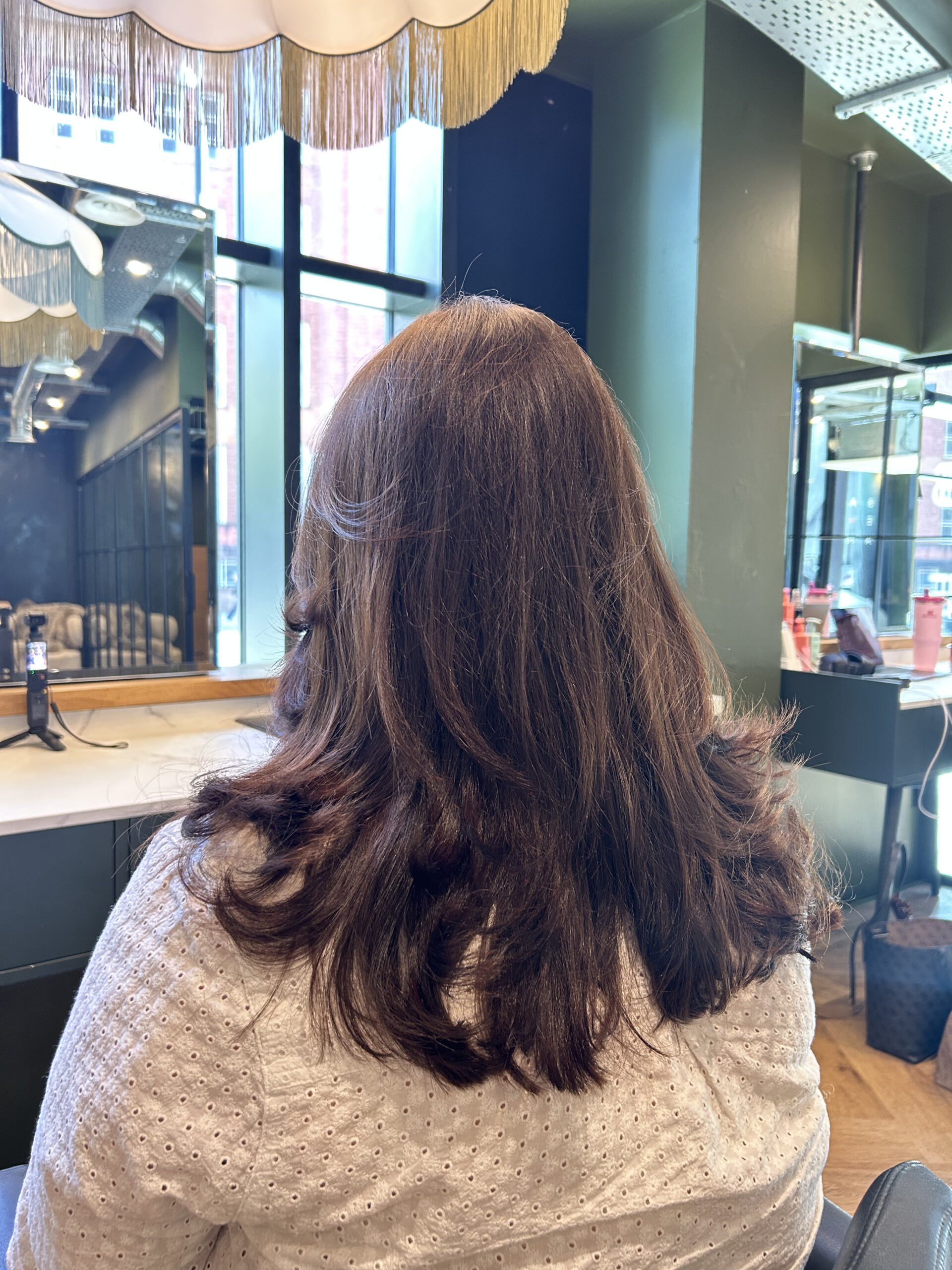 Long brown hair coloured and blown out in manchester hair salon