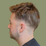 Close-up of a fitted hair system being cut and blended into natural hair