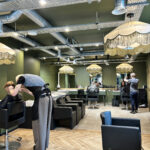 Stylist matching a hair system to a client's natural hair colour in a salon