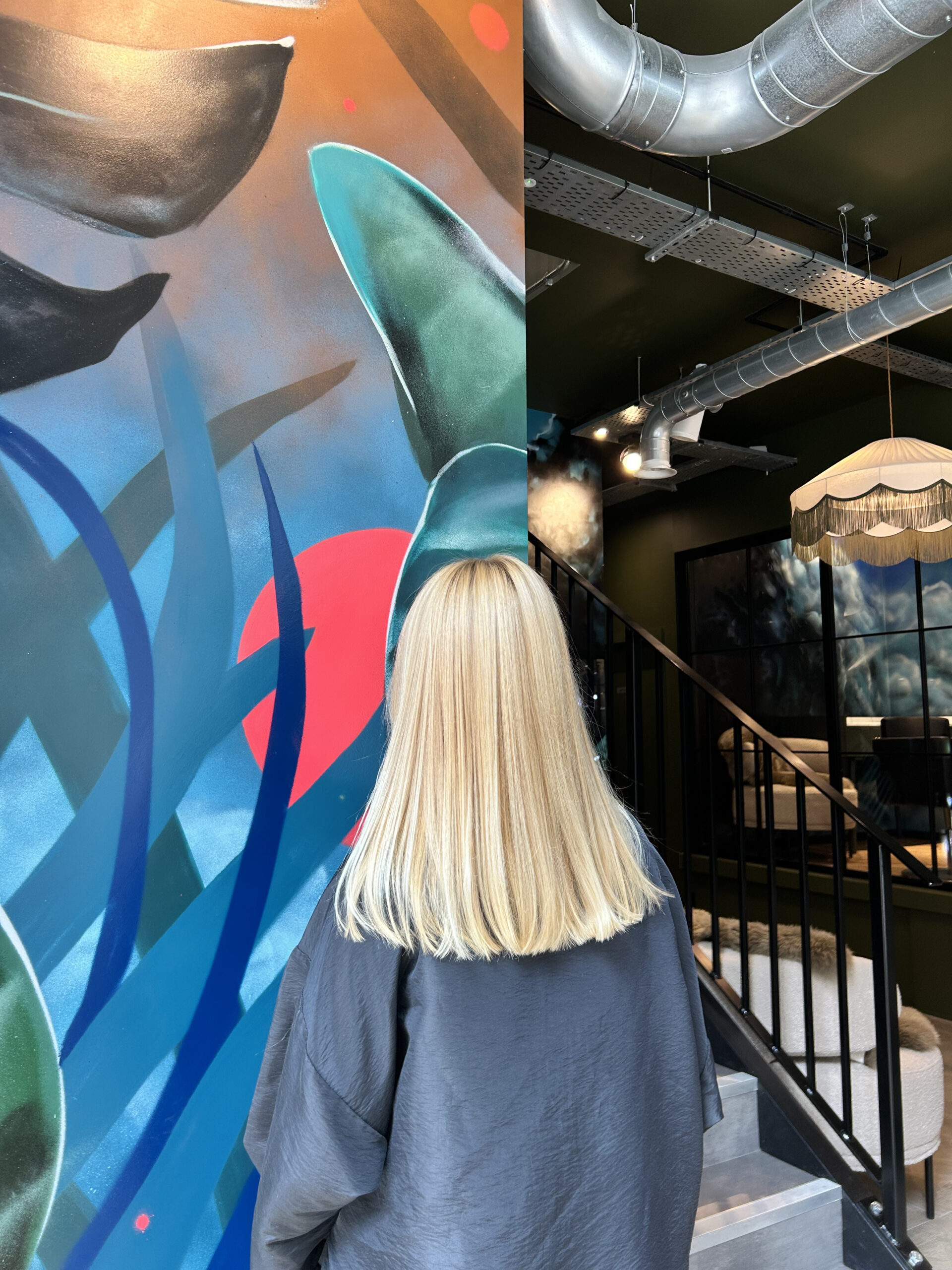 Ladies blonde just below shoulder length hair after her salon appointment