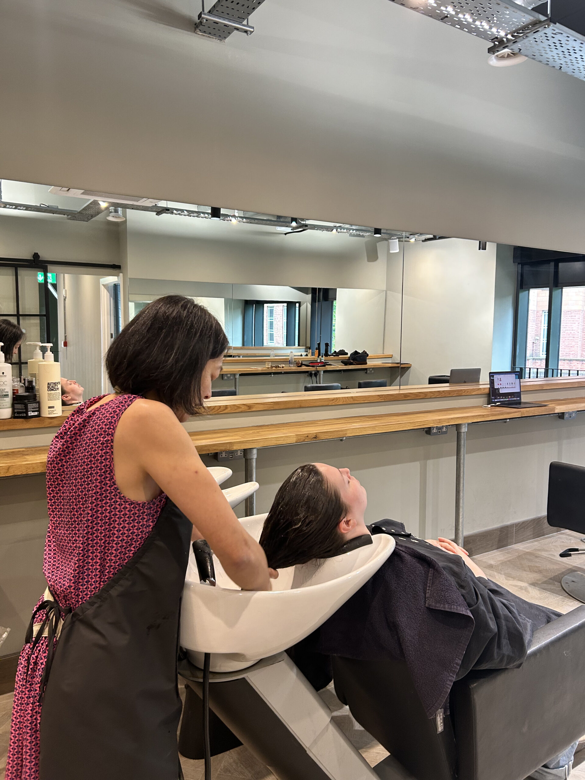 Charlie washing a clients hair at the David Rozman salon